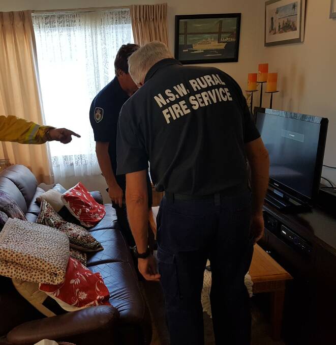 Setting it up: Bonny Hills Rural Fire Brigade firefighters installing a television.