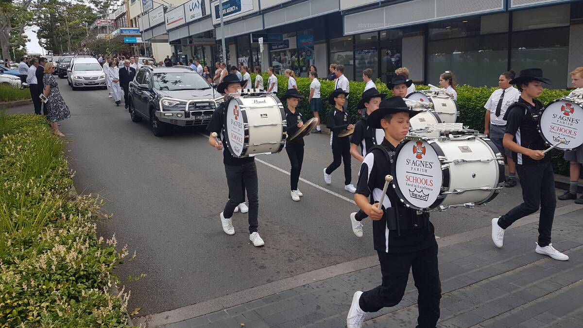Lining the streets: Crowds forming an honour guard along the Hay, William and Horton Streets of Port Macquarie for Father Donnelly.