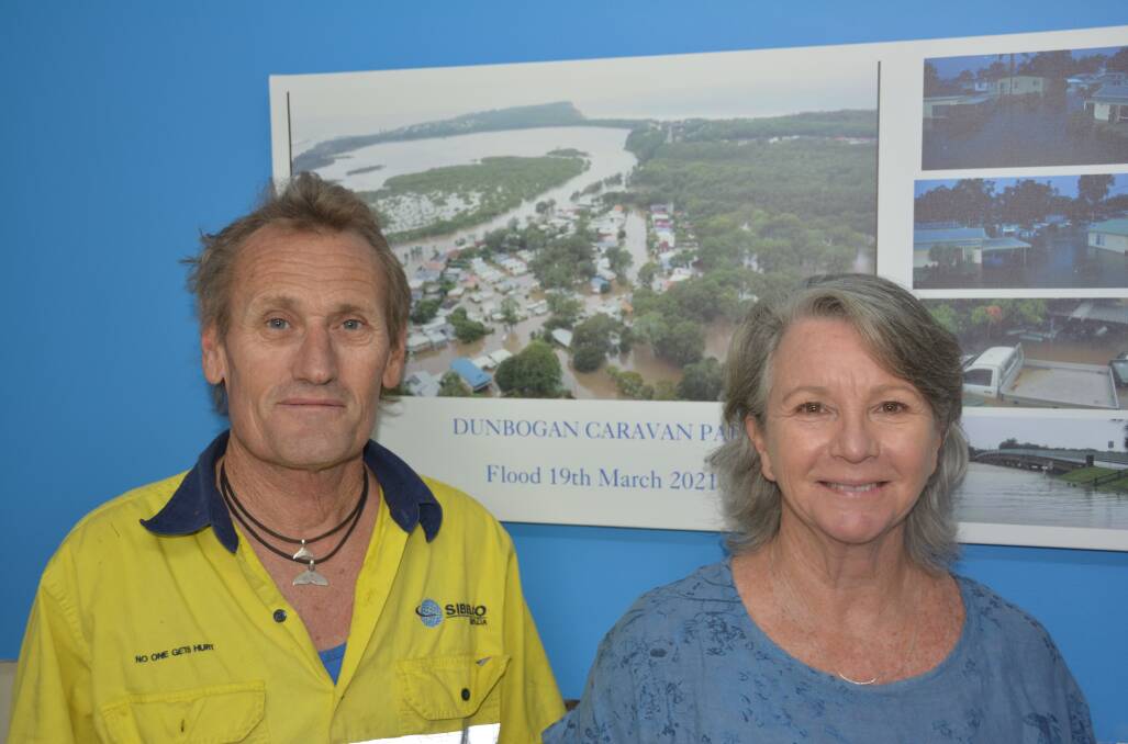 DUNBOGAN CARAVAN PARK: Darrell and Lisa Monk with photos of the March floods.