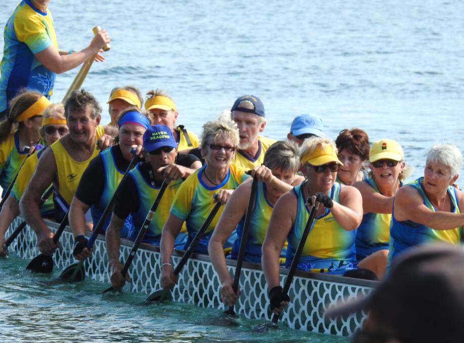 SYDNEY COMPETITION: Robert 'Bob' Woelders (blue cap, middle) and Northern team paddlers competing at the regatta in Penrith. Photo: Camden Haven Dragon Boat Club.