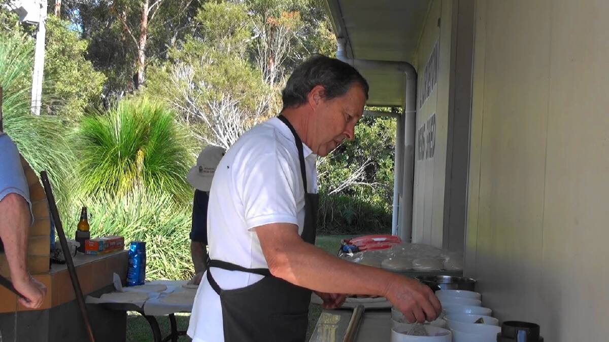 CELEBRATION: Members preparing lunch at the men's shed. Photo: Supplied/Laurieton Men's Shed.