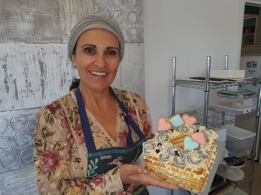 DELICIOUS DESSERTS: Lake Cathie master cake maker Odette Falzon with a handcrafted cake.