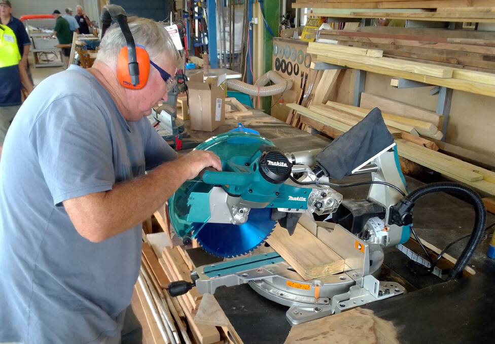 A Kendall Men's Shed member with a new compound Mitre Saw purchased using grant funding. Photo: Kendall Men's Shed Inc.