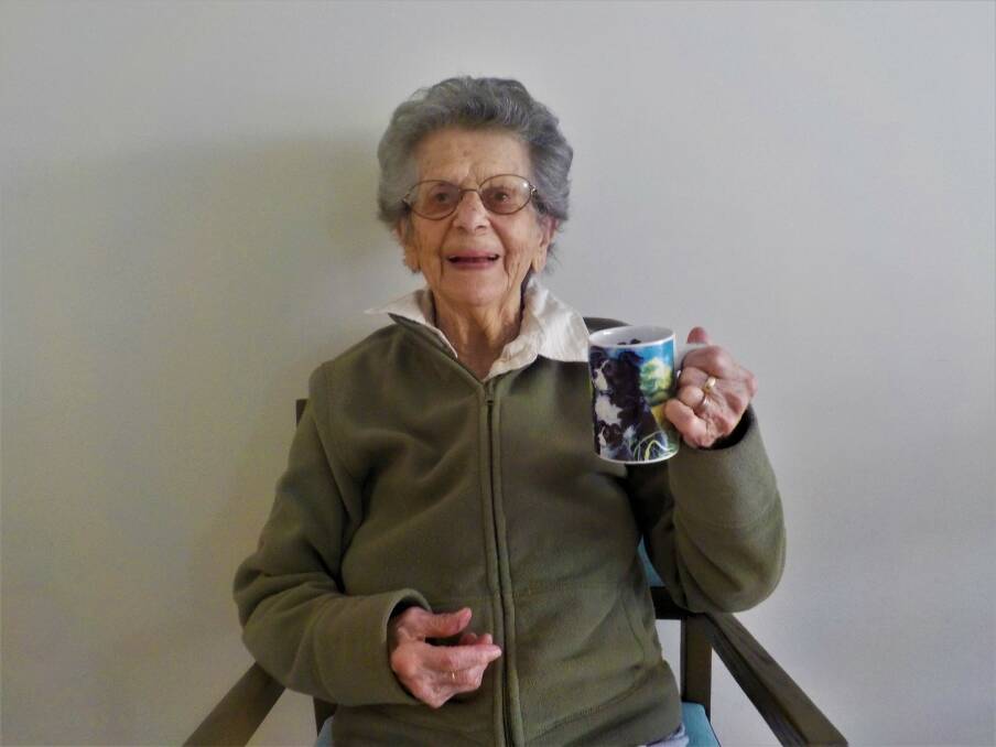 CELEBRATION: Lorne cattle farmer Hazel Monck raises a mug to 100 years. Photo: Laurieton Lakeside Aged Care Residence.