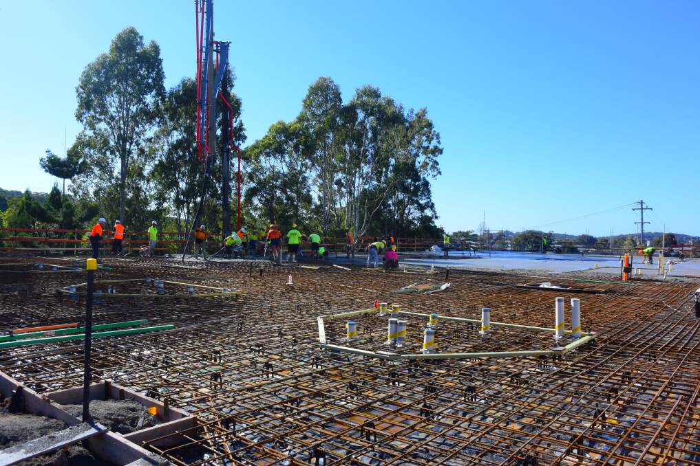 Construction milestone: Workers ensure the concrete pour goes smoothly.