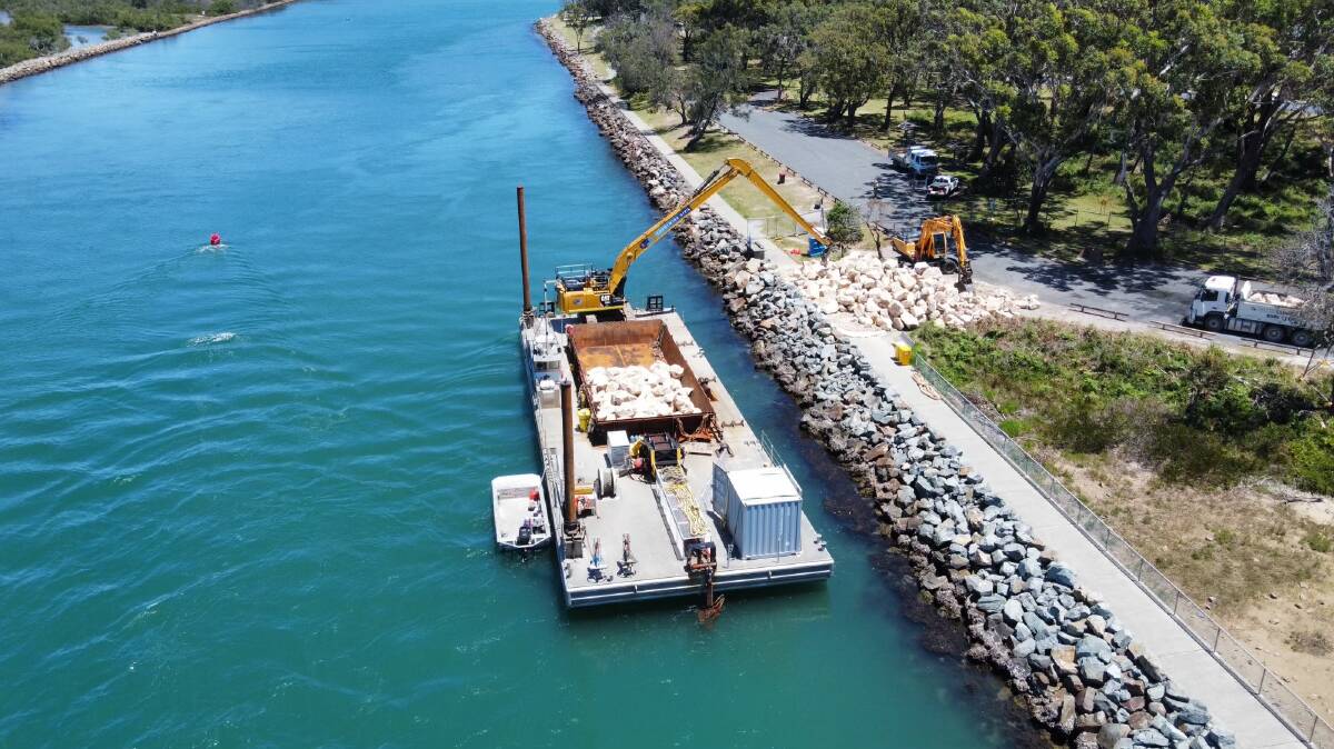 Repair process: A barge is in use as rocks are placed at the North Haven breakwall. Photo: Transport for NSW