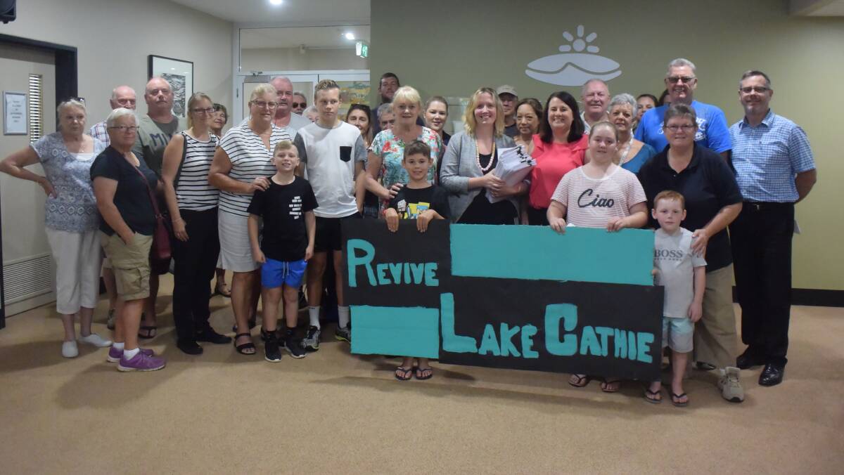 Community action: Revive Lake Cathie volunteers and supporters and council's acting director strategy and growth Holly McBride at the hand over of the submissions.