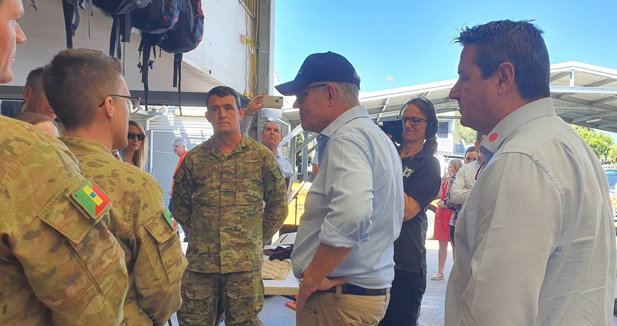 Australian Defence Force representatives chat with Prime Minister Scott Morrison and Cowper MP Pat Conaghan.