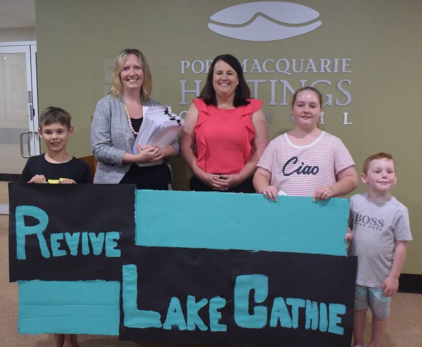 Council's acting director strategy and growth Holly McBride (second from left) accepts the submissions from Revive Lake Cathie president Danielle Maltman as Jayden Schipp, Ryley Dick and Jarryd Schipp look on.