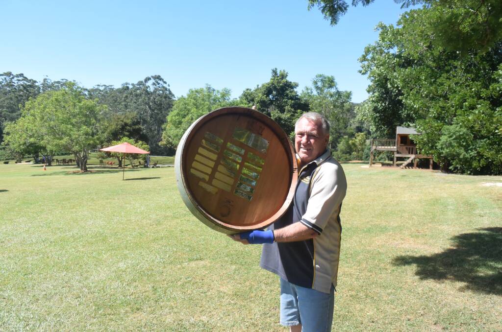 Grape fun: Bago Vineyards spokesperson Ian Adams with the grape stomping championships trophy made from a wine barrel.