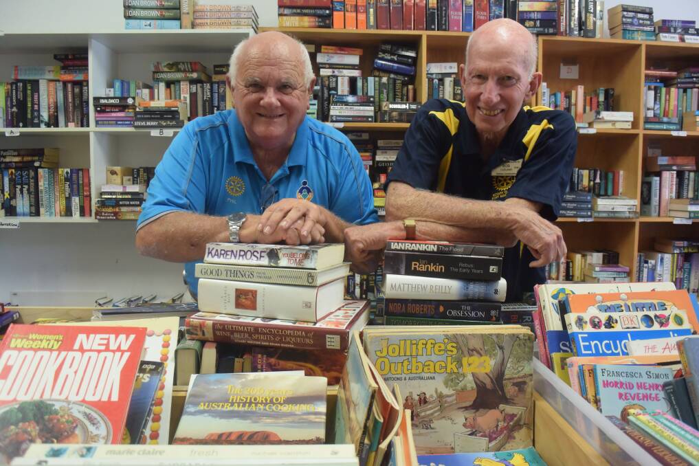 Books galore: Phil Perry and Bob Cleland sort through donated books in the lead-up the Rotary Club of Port Macquarie's Giant Book Sale.