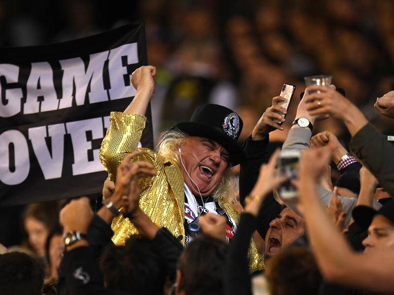 Magpies "super fan" Jeffrey Corfe (in gold jacket) has been accused of sexually abusing a child.