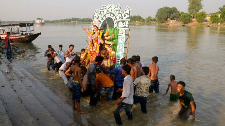 An effigy of Hindu goddess Durga is thrown into the Ganges at the end of a festival. Photo: Louise Southerden
