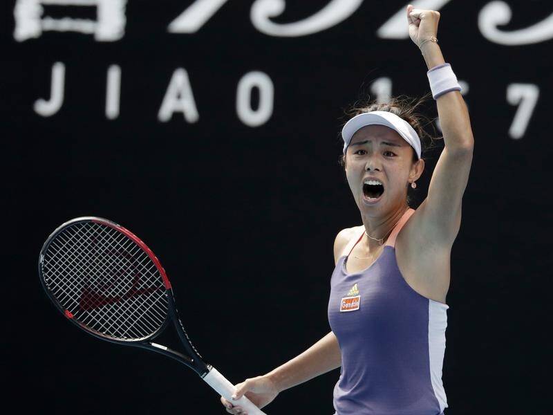Wang Qiang celebrates her stunning Australian Open win over Serena Williams.