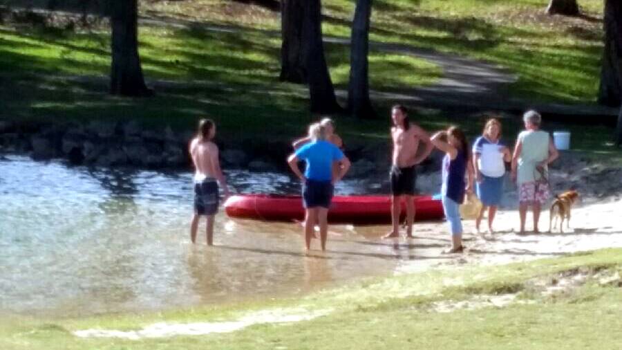 RESCUE: Dan Hunt and Dan Hurd, pictured above in wet shorts, swam into Lake Cathie after noticing the upturned kayak and Santa in the water.