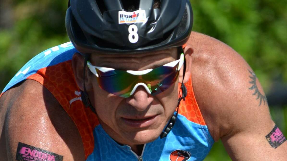 Ironman competitor Jason Shortis photographed during the bike leg through Laurieton in 2014. Photo: Kate Dwyer