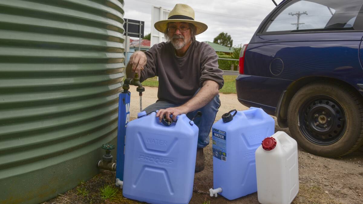 Ringarooma resident Mike Luck fills up his water at the community's communal tank at the recreation ground.