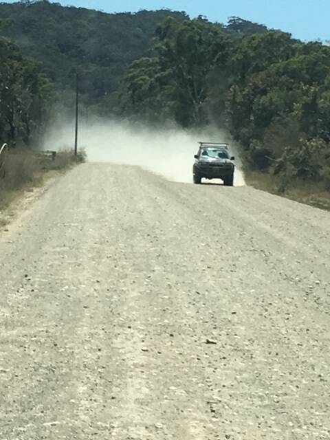 A vehicle travels on the Point Plomer Rd recently, lifting dirt in the air. Photo: Supplied.