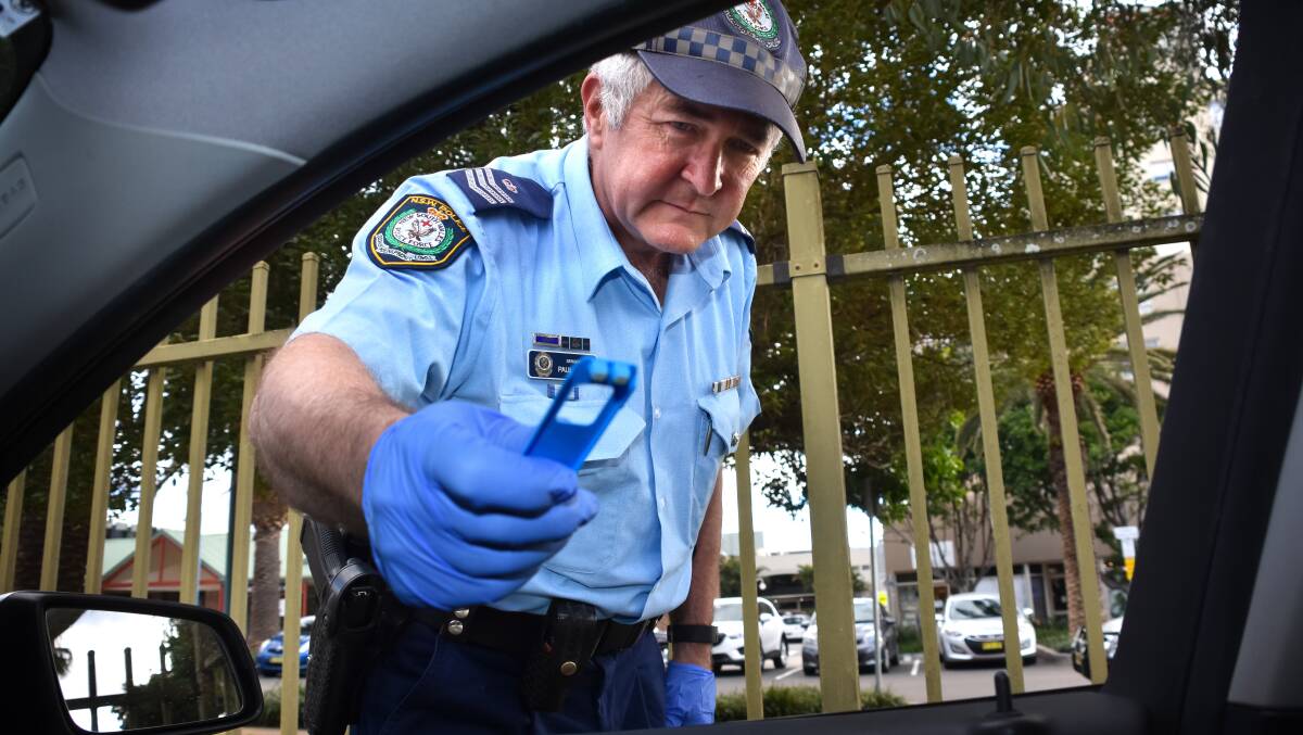Open wide: Highway Patrol Sergeant Paul Dilley with a random drug test kit that is now used regularly on the Mid North Coast.