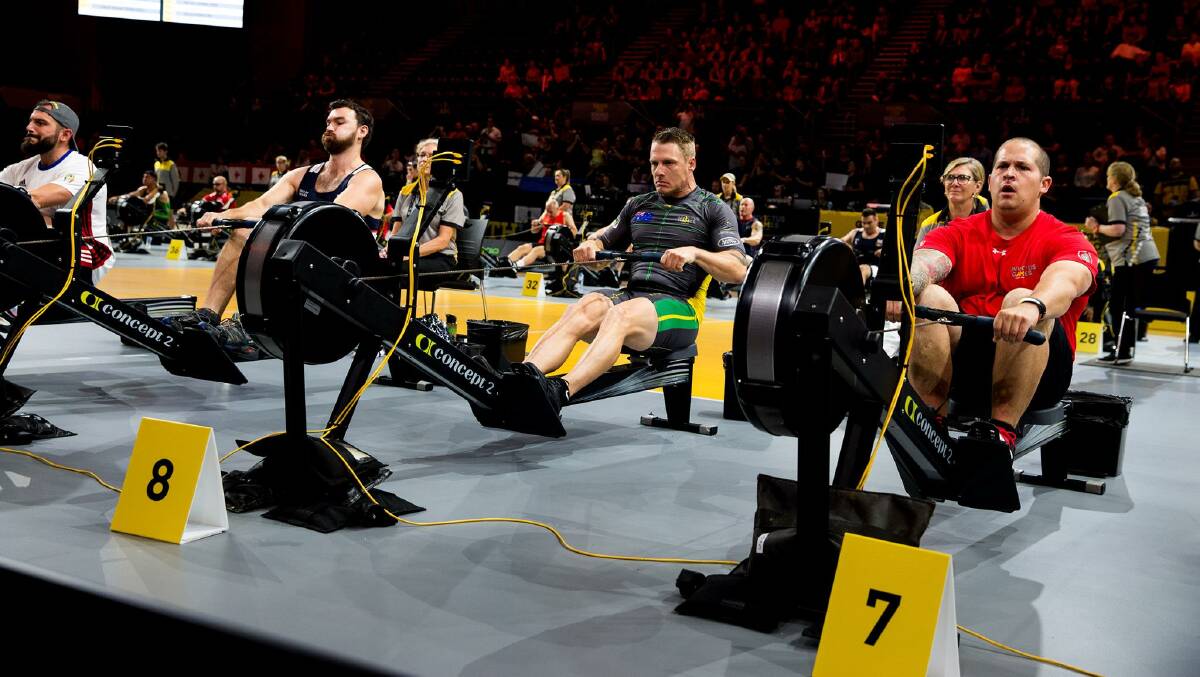 Model, centre, competes at the indoor rowing event in which he won a silver medal.