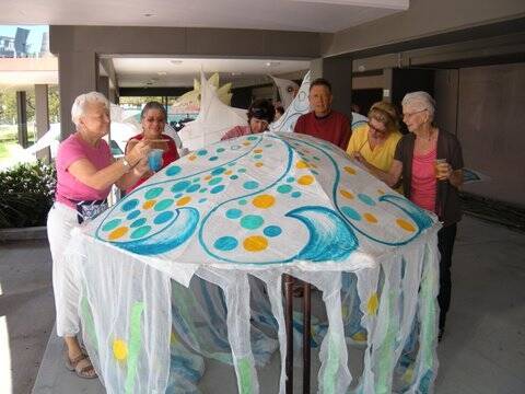 (L to R) Grace Jane, Ruth Lusk, Robyn van Haren, John Lusk, Ida Bruno and Alma Gibson work on their lantern parade project. (Grace and Alma are the founding members of Laurieton’s Sing Australia chapter.)