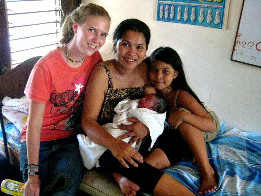 Helping out: Sara Castelijn, left, with one of the mothers at the Shalom Birthing Clinic, Até Joyce, with her new son, Cyrus, and his elder sister. Sara helped her during labour, prayed with her and was with her as she gave birth to a beautiful baby boy.