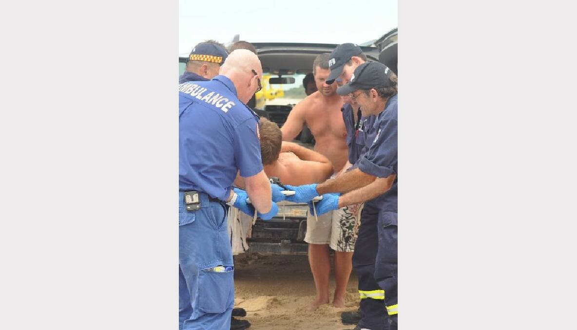 Mates help paramedics and fire rescue from board to stretcher.